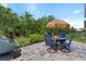 Outdoor patio set for four with a grill and lush landscaping at 7497 W Lenox Cir, Punta Gorda, FL 33950
