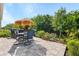 Open patio features a patio table, seating for four, and a grill for outdoor cooking at 7497 W Lenox Cir, Punta Gorda, FL 33950