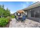 Open patio dining set and garden in backyard near screened in lanai at 7497 W Lenox Cir, Punta Gorda, FL 33950