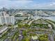 Community aerial featuring a pool, ponds, and beautiful city skyline in background at 846 Normandy Trace Rd, Tampa, FL 33602
