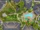 Aerial view of a community featuring a pool, hot tub, lush landscaping, and multiple apartment buildings at 846 Normandy Trace Rd, Tampa, FL 33602