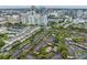 An aerial view of a beautiful community with mature trees and city skyline at 846 Normandy Trace Rd, Tampa, FL 33602