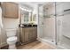 Bathroom features a walk-in shower, modern vanity and updated lighting at 846 Normandy Trace Rd, Tampa, FL 33602