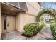 Inviting townhome entrance featuring a decorative trellis and a neutral-colored door at 846 Normandy Trace Rd, Tampa, FL 33602