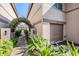 View of a townhome's garage and courtyard entrance with a trellis at 846 Normandy Trace Rd, Tampa, FL 33602