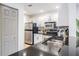 Modern kitchen featuring stainless steel appliances, granite countertops and white cabinetry at 846 Normandy Trace Rd, Tampa, FL 33602