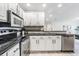 Modern kitchen featuring white cabinetry, stainless steel appliances, and sleek countertops at 846 Normandy Trace Rd, Tampa, FL 33602