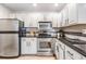 Bright kitchen features stainless steel appliances, granite countertops, and white cabinetry at 846 Normandy Trace Rd, Tampa, FL 33602