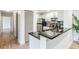 Close up view of modern kitchen with stainless steel appliances and black granite countertops at 846 Normandy Trace Rd, Tampa, FL 33602