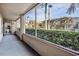 View of a screened patio with green shrubs lining the exterior and trees beyond at 846 Normandy Trace Rd, Tampa, FL 33602