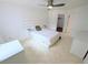 Bright bedroom featuring neutral tile floor, modern bed and a ceiling fan at 8517 Sea Harbour Ln # 103, Temple Terrace, FL 33637