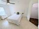 Bedroom featuring neutral tile flooring, a ceiling fan, and an ensuite closet at 8517 Sea Harbour Ln # 103, Temple Terrace, FL 33637