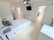 Bright bedroom featuring a ceiling fan, TV, and a modern bed frame with built-in storage drawers at 8517 Sea Harbour Ln # 103, Temple Terrace, FL 33637