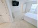 Bedroom featuring neutral tile flooring, white walls and a ceiling fan at 8517 Sea Harbour Ln # 103, Temple Terrace, FL 33637