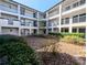 Beautiful condo courtyard with mature landscaping and walkways at 8517 Sea Harbour Ln # 103, Temple Terrace, FL 33637
