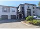 Condo exterior with two-tone paint, two garage doors, and an arched entryway at 8517 Sea Harbour Ln # 103, Temple Terrace, FL 33637