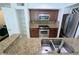 Bright kitchen boasting stainless steel appliances, granite countertops, and a convenient pantry at 8517 Sea Harbour Ln # 103, Temple Terrace, FL 33637