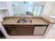 Open kitchen area with granite countertops, stainless steel appliances, and views of the living room at 8517 Sea Harbour Ln # 103, Temple Terrace, FL 33637