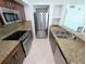Bright kitchen featuring stainless steel appliances, granite countertops, and plenty of space for cooking at 8517 Sea Harbour Ln # 103, Temple Terrace, FL 33637