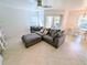Inviting living room with a large gray sectional sofa, a ceiling fan, and an open dining area at 8517 Sea Harbour Ln # 103, Temple Terrace, FL 33637
