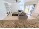 Comfortable living room featuring a plush gray sectional sofa and sliding glass doors to the outside at 8517 Sea Harbour Ln # 103, Temple Terrace, FL 33637