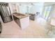 Bright living room seamlessly connects with the kitchen's granite countertop and stainless steel appliances at 8517 Sea Harbour Ln # 103, Temple Terrace, FL 33637