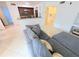 Modern living space featuring tile flooring, a gray sectional sofa, and an open layout at 8517 Sea Harbour Ln # 103, Temple Terrace, FL 33637