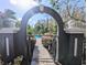 Charming gated entrance leading to a community pool surrounded by flourishing vegetation at 8517 Sea Harbour Ln # 103, Temple Terrace, FL 33637