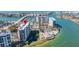 Scenic aerial view of the condo community with a pool, marina, and tennis courts at 9425 Blind Pass Rd # 506, St Pete Beach, FL 33706
