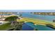 Picturesque aerial view of canal with mature landscaping, boat, and waterfront homes at 9425 Blind Pass Rd # 506, St Pete Beach, FL 33706