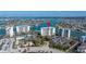 Beautiful aerial view of condo complex on the water featuring a pool and ample parking at 9425 Blind Pass Rd # 506, St Pete Beach, FL 33706