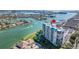 Stunning aerial view of the waterfront condo complex with boat docks and bay access at 9425 Blind Pass Rd # 506, St Pete Beach, FL 33706