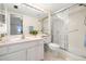 Well-lit bathroom with a shower, vanity, and tile flooring at 9425 Blind Pass Rd # 506, St Pete Beach, FL 33706