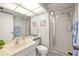 Bright bathroom featuring a glass shower, sink with ample counter space, and decorative accents at 9425 Blind Pass Rd # 506, St Pete Beach, FL 33706