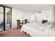 Cozy bedroom with balcony access, a ceiling fan, and comfortable furnishings at 9425 Blind Pass Rd # 506, St Pete Beach, FL 33706