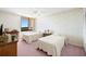 Bright bedroom with two twin beds, a large window, and wallpapered walls at 9425 Blind Pass Rd # 506, St Pete Beach, FL 33706