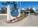 Entrance to Yacht & Tennis Club with a beautifully landscaped sign and well-maintained guard house at 9425 Blind Pass Rd # 506, St Pete Beach, FL 33706