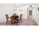Dining room featuring a chandelier, a sign that says St Pete Beach, and a hallway leading to the entryway at 9425 Blind Pass Rd # 506, St Pete Beach, FL 33706