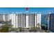 Condo with multiple stories and balconies surrounded by parking and landscaping at 9425 Blind Pass Rd # 506, St Pete Beach, FL 33706