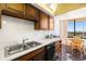 Kitchen with stainless steel sink and seating area overlooking the water at 9425 Blind Pass Rd # 506, St Pete Beach, FL 33706