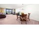 Open concept living and dining area with water views and a plush carpet at 9425 Blind Pass Rd # 506, St Pete Beach, FL 33706