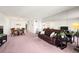 Open-concept living and dining area with a large couch, mirrored wall, and dining table at 9425 Blind Pass Rd # 506, St Pete Beach, FL 33706