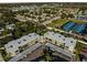 Aerial view of a residential complex with mature trees and green spaces at 952 Virginia St # 108, Dunedin, FL 34698