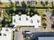Aerial view of a building with a parking lot surrounded by trees and lawn at 952 Virginia St # 108, Dunedin, FL 34698