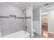 Renovated bathroom with modern tile shower and convenient access to the dining area at 952 Virginia St # 108, Dunedin, FL 34698