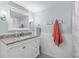 Bright bathroom features granite counters, a large mirror, and modern fixtures at 952 Virginia St # 108, Dunedin, FL 34698