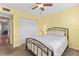 Comfortable bedroom includes a ceiling fan and closet for storage at 952 Virginia St # 108, Dunedin, FL 34698