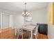 Dining area featuring a table with four chairs and a modern chandelier above at 952 Virginia St # 108, Dunedin, FL 34698