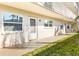 Front of building with walkway, door, and two windows with lots of natural light at 952 Virginia St # 108, Dunedin, FL 34698