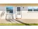 Exterior view of the front entrance with two windows on either side of the door at 952 Virginia St # 108, Dunedin, FL 34698